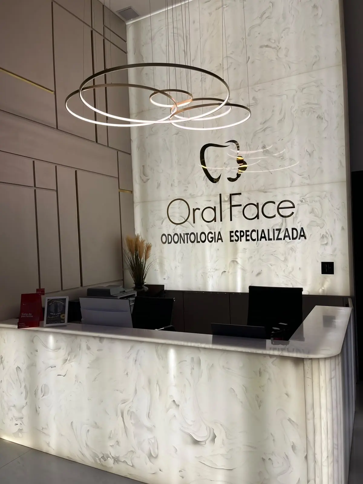 Recepção da Oral Face, com o logo no mármore